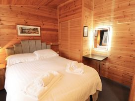 A bedroom with a bed and towels on top at The Fold, Number 28, Burnside Park near Keswick