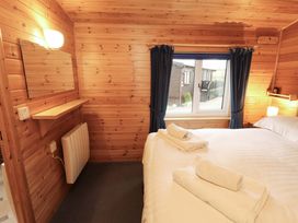 A bedroom with a bed and towels arranged at The Fold near Keswick