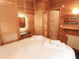 A bedroom with a bed and mirror at The Fold near Keswick