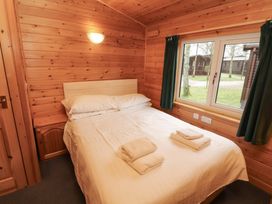 A bedroom with a bed and window at The Fold Number 28, Burnside Park near Keswick