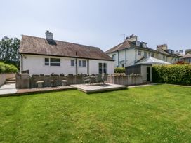 A garden with a house and patio area at Driftwood Cottage in Keswick