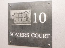 A house number sign displaying 10 Somers Court with an image of the building at Apartment 4 10 Somers Court in Paignton