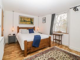 A bedroom with a wooden bed and bedside tables with lights at Apartment 4 10 Somers Court in Paignton