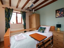 A bedroom with a hospital bed and window at Chomley @ Summerfield Farm, Hawsker