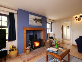 A living room with a fireplace and a sofa at Albany @ Summerfield Farm in Hawsker