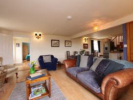 A living room with a sofa, armchair, and coffee table at Albany @ Summerfield Farm, Hawsker