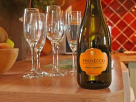 A bottle of Prosecco and glasses on a table at Albany @ Summerfield Farm in Hawsker