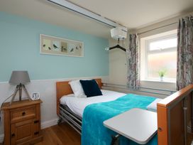 A bedroom with a bed and accessories at Albany @ Summerfield Farm, Hawsker