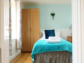 A bedroom with a bed and wardrobe at Albany @ Summerfield Farm Hawsker