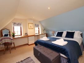 A bedroom with a bed and vanity mirror at Albany @ Summerfield Farm in Hawsker