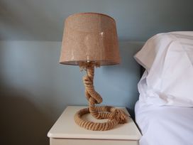 A lamp shaped like a rope on a bedside table at Albany @ Summerfield Farm in Hawsker