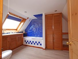 A bathroom with a bathtub and sink at Albany @ Summerfield Farm in Hawsker