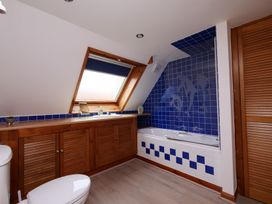 A bathroom with a bathtub, toilet, and sink at Albany @ Summerfield Farm in Hawsker
