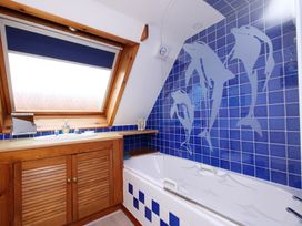 A bathroom with a bathtub and a sink at Albany @ Summerfield Farm in Hawsker