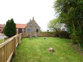 A house with a fenced lawn and chairs at Albany @ Summerfield Farm in Hawsker