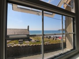 A view of the ocean and beach from a window at 4 Bryn Llan Aberdaron