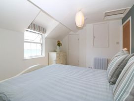 A bedroom with a bed and window at 4 Bryn Llan Aberdaron