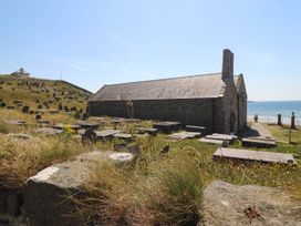 A church near a graveyard by the sea at 4 Bryn Llan in Aberdaron