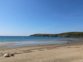 A beach with sand and people walking at 4 Bryn Llan in Aberdaron