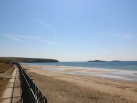A beach with sand and water at 4 Bryn Llan Aberdaron