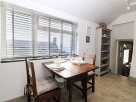 A dining room with a table and chairs at 5 Bryn Llan Pwllheli