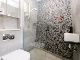 A bathroom with a shower and toilet at 5 Bryn Llan in Pwllheli