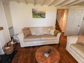 A living room with a sofa and a table at Bridge End Cottage Haverthwaite near Cartmel