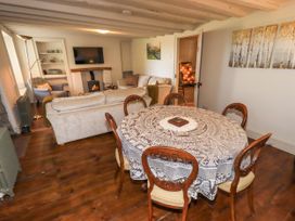 A dining room with a table and chairs at Bridge End Cottage Haverthwaite near Cartmel