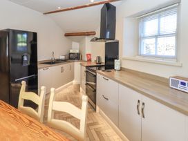 A kitchen with appliances and cabinetry at Bridge End Cottage in Haverthwaite near Cartmel