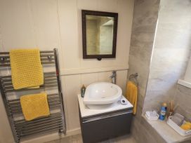 A bathroom with a sink and towel warmer at Bridge End Cottage in Haverthwaite near Cartmel