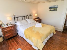 A bedroom with a bed and bedside tables at Bridge End Cottage in Haverthwaite near Cartmel