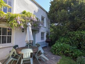 An outdoor patio with a table and chairs at Bridge End Cottage in Haverthwaite near Cartmel
