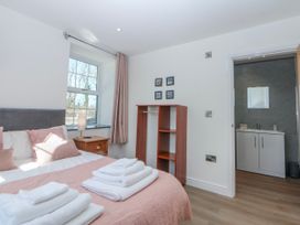 A bedroom with a bed and vanity unit at Gate House Capel Coch near Llanerchymedd