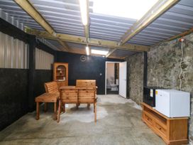 A room with wooden furniture and appliances at Gate House near Llanerchymedd