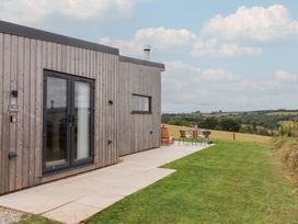 An outdoor space with a cabin and seating area at The Cadeleigh near Tiverton