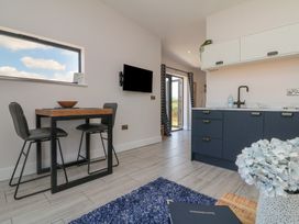 A kitchen with a dining table and chairs at The Cadeleigh near Tiverton