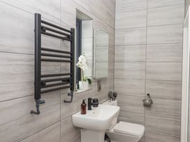 A bathroom with a towel radiator and sink at The Cadeleigh in Cadeleigh near Tiverton