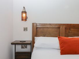 A bedroom with a bed and bedside table at The Cadeleigh in Cadeleigh near Tiverton