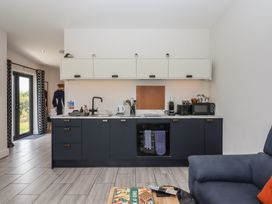 A kitchen with cabinets and appliances at The Cadeleigh Cadeleigh near Tiverton