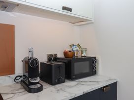 A kitchen counter with an espresso machine, toaster, and microwave at The Cadeleigh near Tiverton