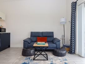A living room with a sofa and table at The Cadeleigh near Tiverton