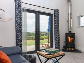 A living room with a stove and coffee table at The Cadeleigh near Tiverton