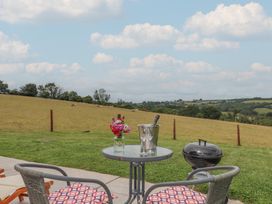 A table with chairs and a champagne bucket at The Cadeleigh Cadeleigh near Tiverton