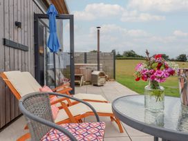 An outdoor area with deck chairs and a table at The Cadeleigh near Tiverton