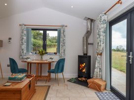 A dining room with a table and chairs at The Pennymoor in Cadeleigh near Tiverton