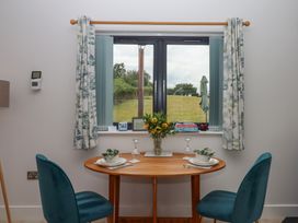 A dining room with a table and chairs at The Pennymoor in Cadeleigh near Tiverton