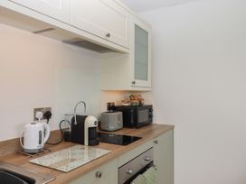 A kitchen with appliances including a kettle and coffee machine at The Pennymoor in Cadeleigh near Tiverton