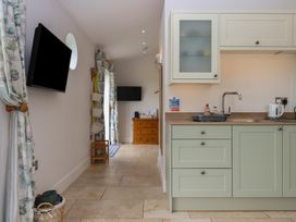 A kitchen with a sink and cabinets at The Pennymoor in Cadeleigh near Tiverton