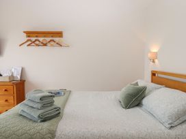 A bedroom with a bed and towels on top at The Pennymoor in Cadeleigh near Tiverton