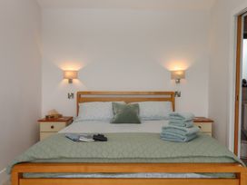 A bedroom with a bed and towels at The Pennymoor in Cadeleigh near Tiverton